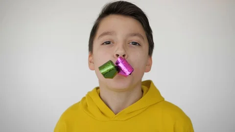 Boy having fun and blows a whistle Stock Footage 128048321