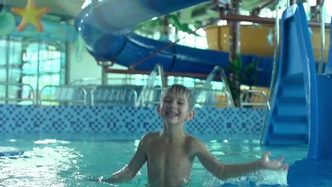 Boy having fun in aquapark in slow motion Stock Footage 81922864