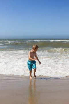 Boy having fun at beach Stock Photos