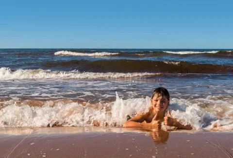 Boy is having fun on beach Stock Photos