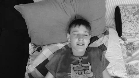 Boy having fun falling back on the bed Delayed frames. Good mood Video stock 125986165