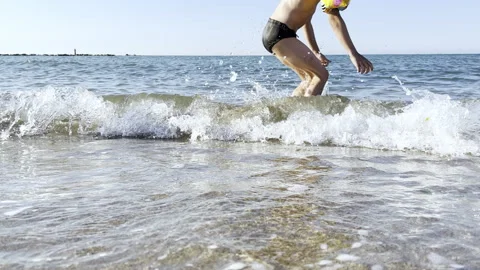 Boy Having Fun Jumping In Sea Waves Stock Footage 217698769