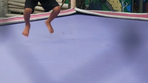 Boy is having fun jumping on a trampoline Stock Footage 310244115