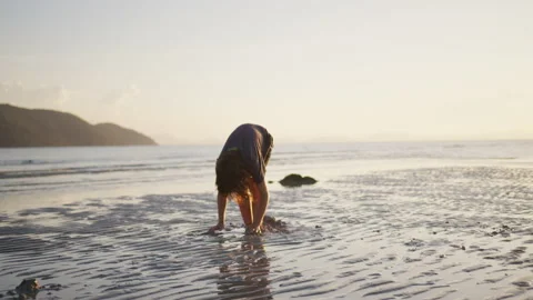 Boy having fun playing on the sea beach with sand at sunset. The concept of Stock Footage 191468905