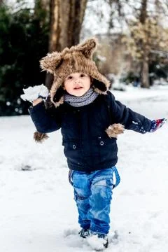 Boy having fun in the snow Stock Photos
