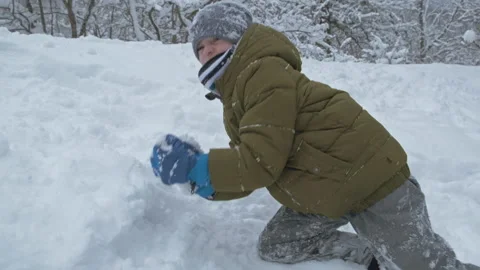 Boy having fun with snow in winter park in vacation Stock Footage 147291562
