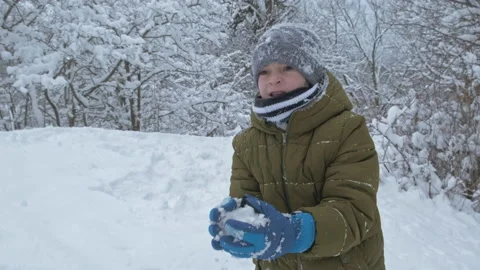Boy having fun with snow in winter park in vacation Stock Footage 147608467