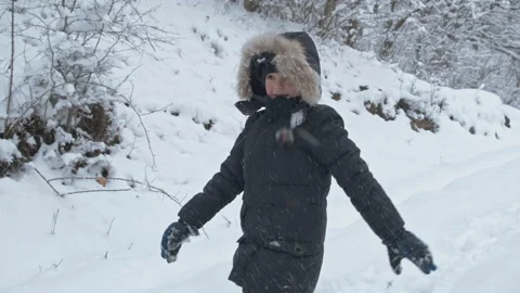 Boy having fun with snow in winter park in vacation Stock Footage 149737331