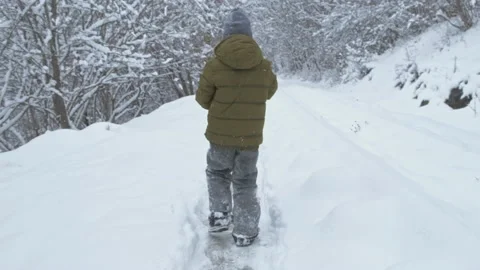 Boy having fun with snow in winter park in vacation Stock Footage 149745119
