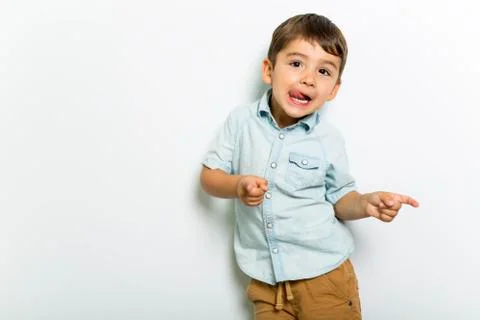 Boy having fun on studio grey background Stock-Fotos