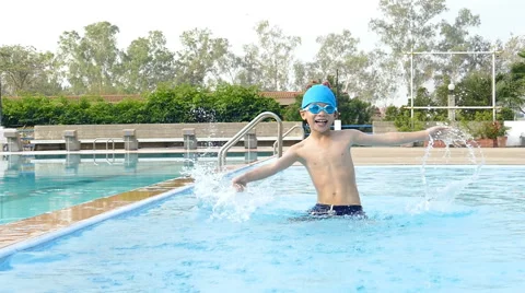 Boy having fun in swimming pool Stock Footage 61947473