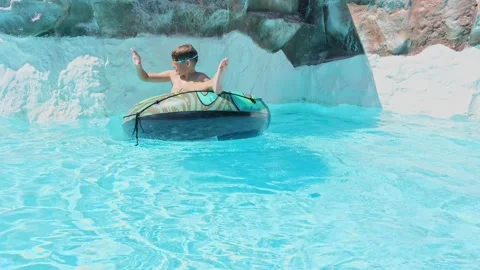 Boy Having Fun in the Swimming Pool On Inner Tube. Summer Vacation Fun. Stock Footage 169954165
