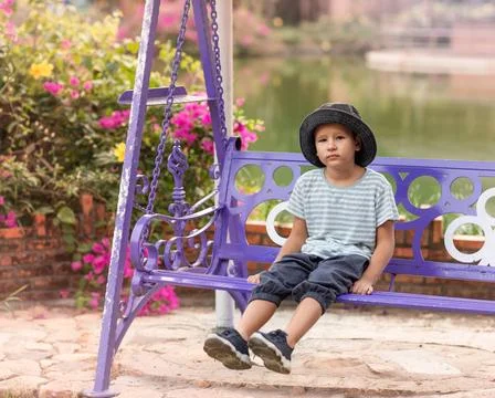 Boy having fun on the swing Boy having fun in the park on a swing ,model r... Fotos Stock