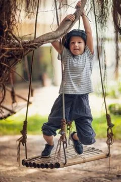 Boy having fun on the swing Boy having fun time on the swing ,model releas... Foto stock