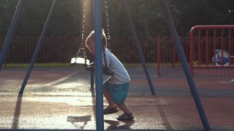 Boy having fun on the swing Stock Footage 79976313