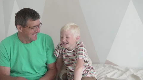The boy is having fun talking to his grandfather at home Stock Footage 136026132