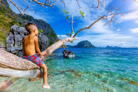 Boy having fun on tropical beach Fotos Stock
