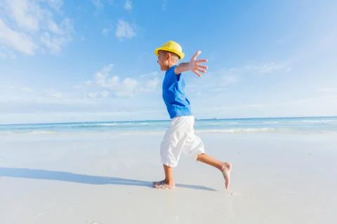 Boy having fun on tropical ocean beach. Kid during family sea vacation. 写真素材