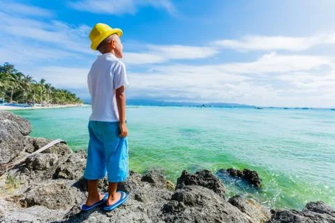 Boy having fun on tropical ocean beach. Kid during family sea vacation. 写真素材