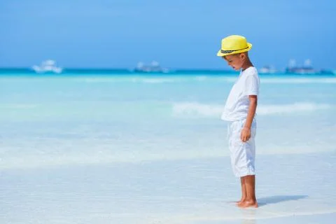 Boy having fun on tropical ocean beach. Kid during family sea vacation. 写真素材