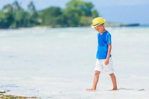 Boy having fun on tropical ocean beach. Kid during family sea vacation. 写真素材