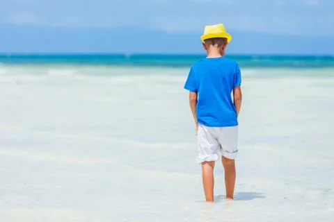 Boy having fun on tropical ocean beach. Kid during family sea vacation. 写真素材