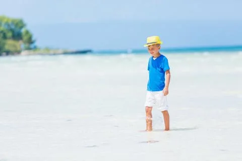 Boy having fun on tropical ocean beach. Kid during family sea vacation. Fotos Stock