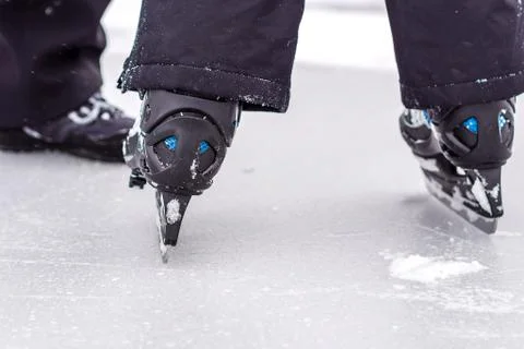 Boy is having fun while skating on natural ice Stock Photos