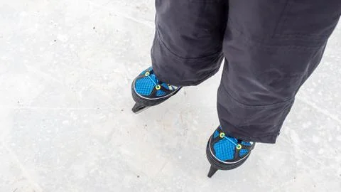 Boy is having fun while skating on natural ice Stock Photos