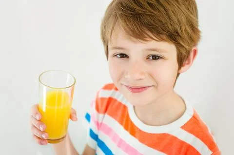 Boy having a glass of refreshing fruit juice Stock Photos