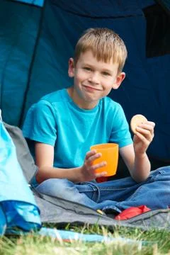 Boy Having Snack On Camping Trip Stock Photos