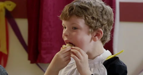 Boy having snacks during a birthday party Stock Footage 58579047