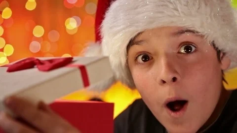 Boy having a wow moment opening his christmas present Stock Footage 80185225