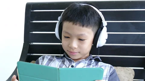 Boy in headphone using tablet computer Stock Footage 68231760