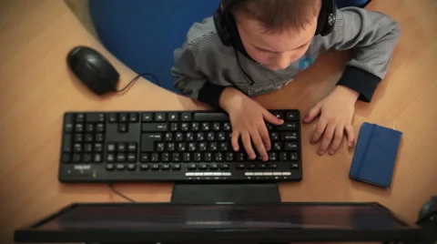 Boy in headphones playing computer games Stock Footage 62497366