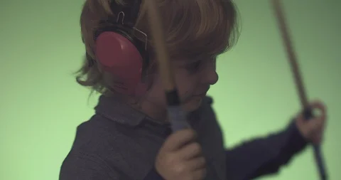 Boy with headphones playing drum Stock Footage 99991360