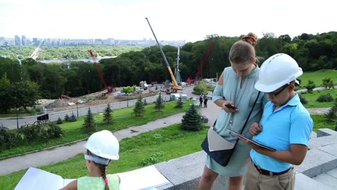 A boy in a helmet reports on the progress of construction. Stock Footage 97266145