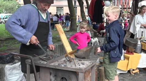 The boy helps the blacksmith at work, Riga, Latvia Vídeo Stock 66311549
