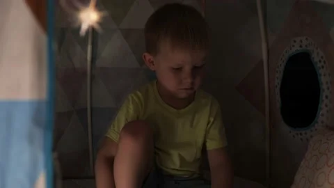 The boy hid in a children's hut to read a book. Stock Footage 236558552