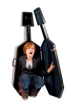 Boy hiding in a cello box Stock Photos