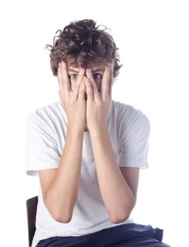 Boy hiding face with his hands Stock Photos