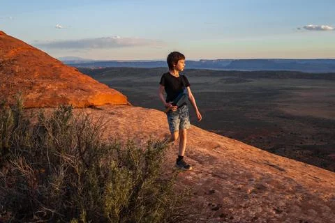 Boy Hiking at Sunset on Devils Garden Trail, Utah Stock Photos
