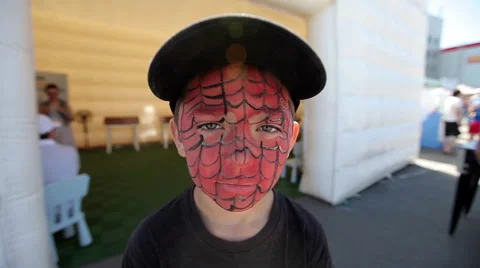 A boy with his face painted smiles Stock Footage 54027965