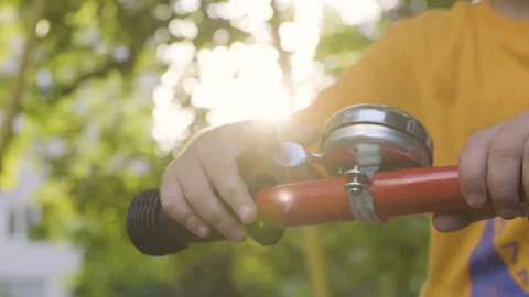 Boy with his finger presses the trigger of a metal bell Stock Footage 172016363