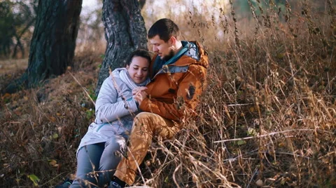 Boy with his girlfriend having fun outside on golden hill. Young couple relaxing Stock Footage 65466967