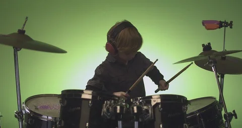 Boy hitting drum and crash cymbal with drum stick in slow motion Stock Footage 99990741
