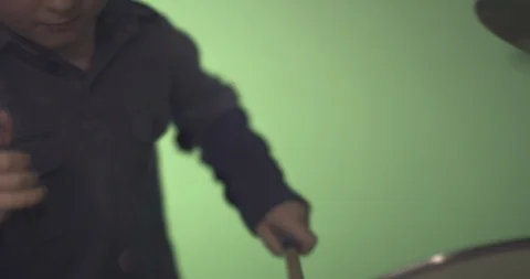 Boy hitting drum with drum stick Stock Footage 99991386