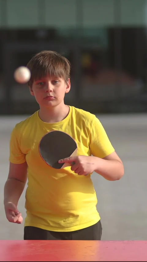 Boy hitting ping pong ball in action. Vertical video Stock Footage 336306689