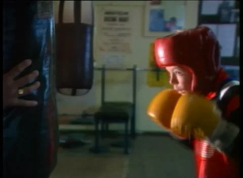 BOY HITTING PUNCHING BAG (1989) Stock Footage 247385407