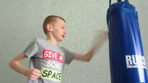 Boy hitting a punching bag Stock Footage 209184828